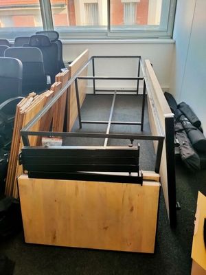 a bed frame that is sitting in the middle of a room