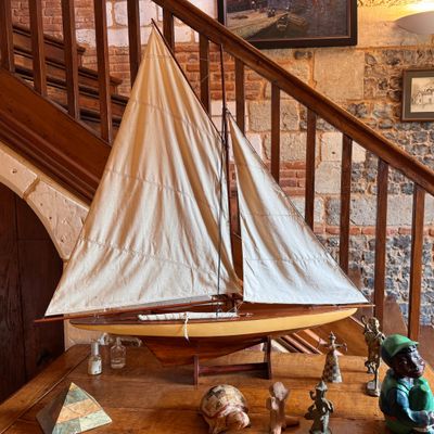a small sailboat on a table in front of a staircase