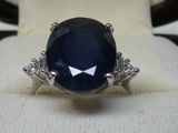 an image of a ring with a blue stone on it