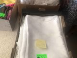 two boxes of clothes and a bag of clothes on the floor