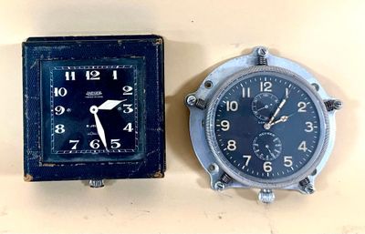 two clocks that are sitting next to each other on a table