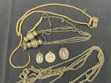 a lot of gold necklaces on a black surface