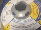 a blue spool with a white disc on it in a box