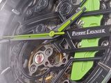 a close up of a watch with a green second hand