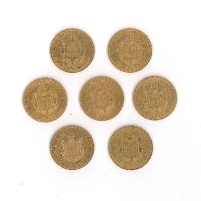 six old british coins on a white surface