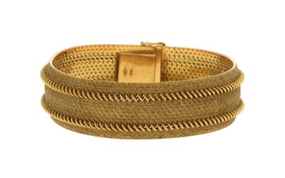 gros plan d'un bracelet en or sur fond blanc
