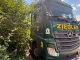 a green truck that is parked on the side of the road