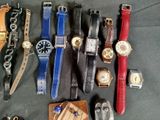 a lot of watches that are sitting on a table