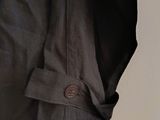 a close up of a jacket hanging on a hook on a wall