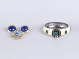 two rings and a ring with blue stones on a white surface