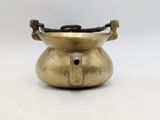 an old brass pot with a handle on a white background