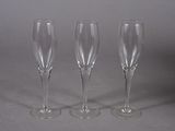 three empty wine glasses sitting next to each other on a table