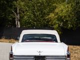 a white car that is parked on the side of the road