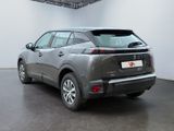 the rear view of a grey car parked in a garage