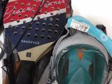 two paddles and a mask in a mesh bag