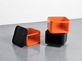 two orange and black boxes sitting on top of a cement floor