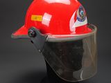 a close up of a red hard hat with a clear vise