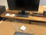 a desk with a laptop, a monitor, and other electronics on it