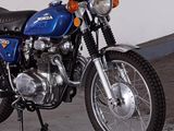 a blue motorcycle that is parked in a garage
