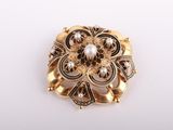 an image of a gold brooch with pearls and diamonds