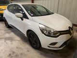 La voiture blanche est garée dans le garage, à côté d'autres voitures.
