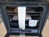 a roll of toilet paper hanging out of an oven door