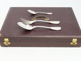 four forks and spoons in a box on the table