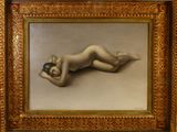 une image représentant une femme nue allongée sur le ventre, dans un cadre doré