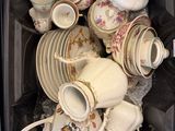 a black container filled with many different types of tea cups and saucers