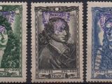 a close up of four different colored stamps on a black background