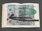 an open book with a picture of a tree and a bird on it