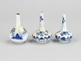 three blue and white vases sitting next to each other on a table