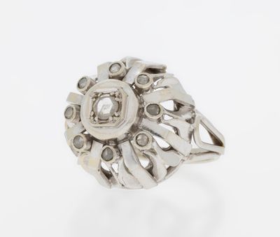 a close up of a silver ring with diamonds on it