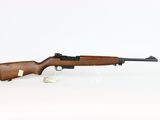 a rifle on a white surface with a white background