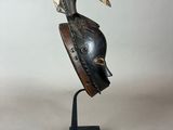 a close up of a sculpture of a bird wearing a helmet