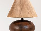 une lampe en bois munie d'un abat-jour marron