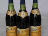 three bottles of wine are lined up on a marble surface