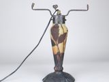 an old fashioned lamp with a black and brown shade on a white background