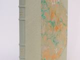 a book that is sitting on a white surface
