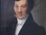 portrait of a man in a black coat and white shirt
