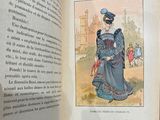 an open book with a picture of a woman in a blue dress