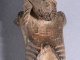 a statue of a man holding a fish in his hands