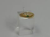 an image of a gold ring with a green stone on it