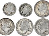 six types différents de pièces d'argent sur fond blanc