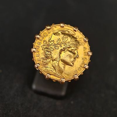 gros plan d'une pièce d'or portant un visage de femme