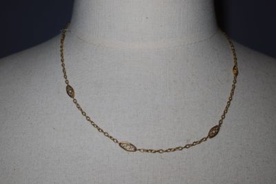a close up of a mannequin torso with a necklace on it
