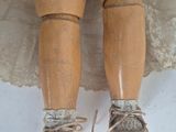 a close up of a doll ' s legs with a dress and shoes