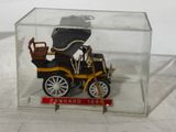 a small toy car in a clear box on a table