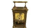 a gold clock that is sitting on top of a table