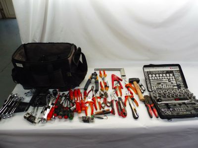 une table sur laquelle sont posés divers outils et un sac